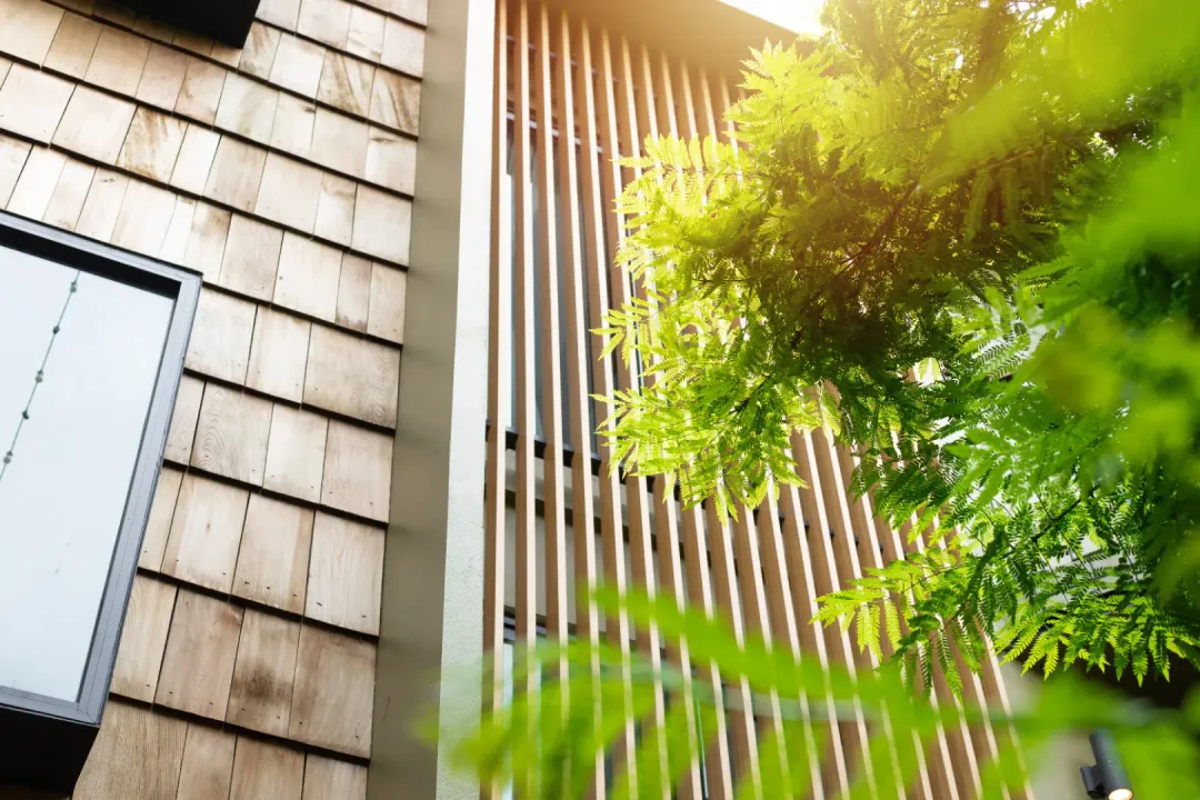 Wooden louvers on a house exterior that add a natural look and let air pass through.