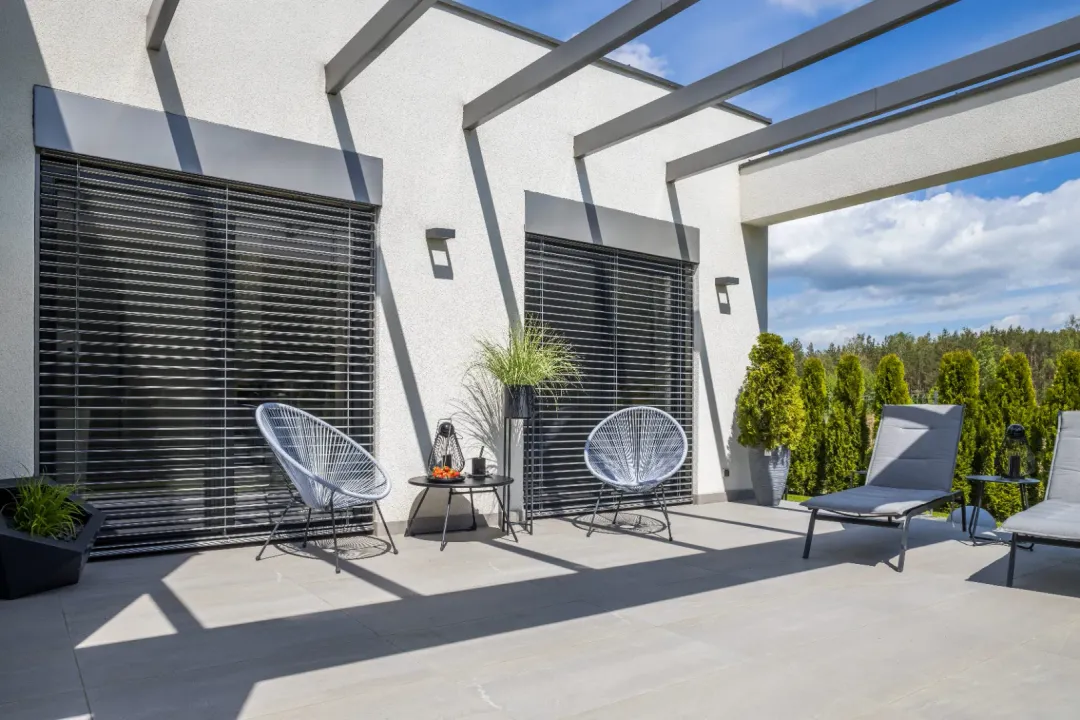 Black louvers on a modern house patio that provide shade and privacy.
