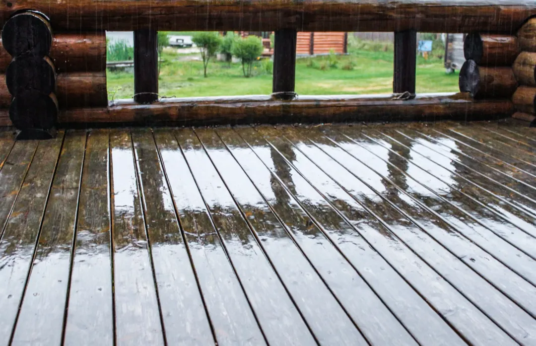 A fully rinsed cleaned composite deck outside a house