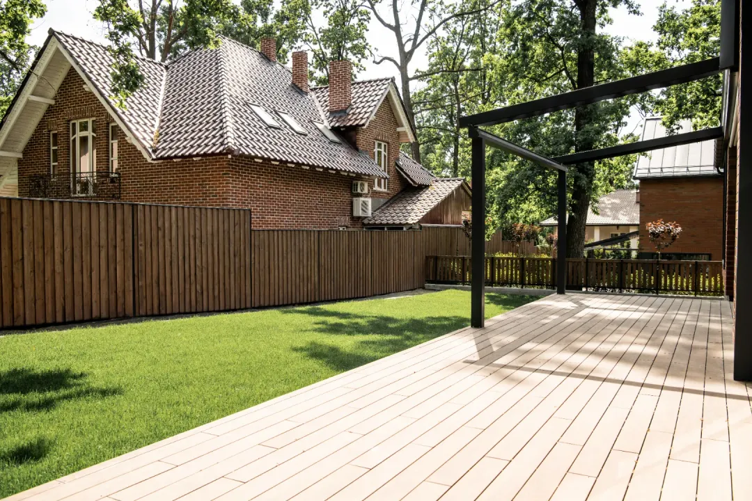 A composite deck outside a house with all the furniture removed