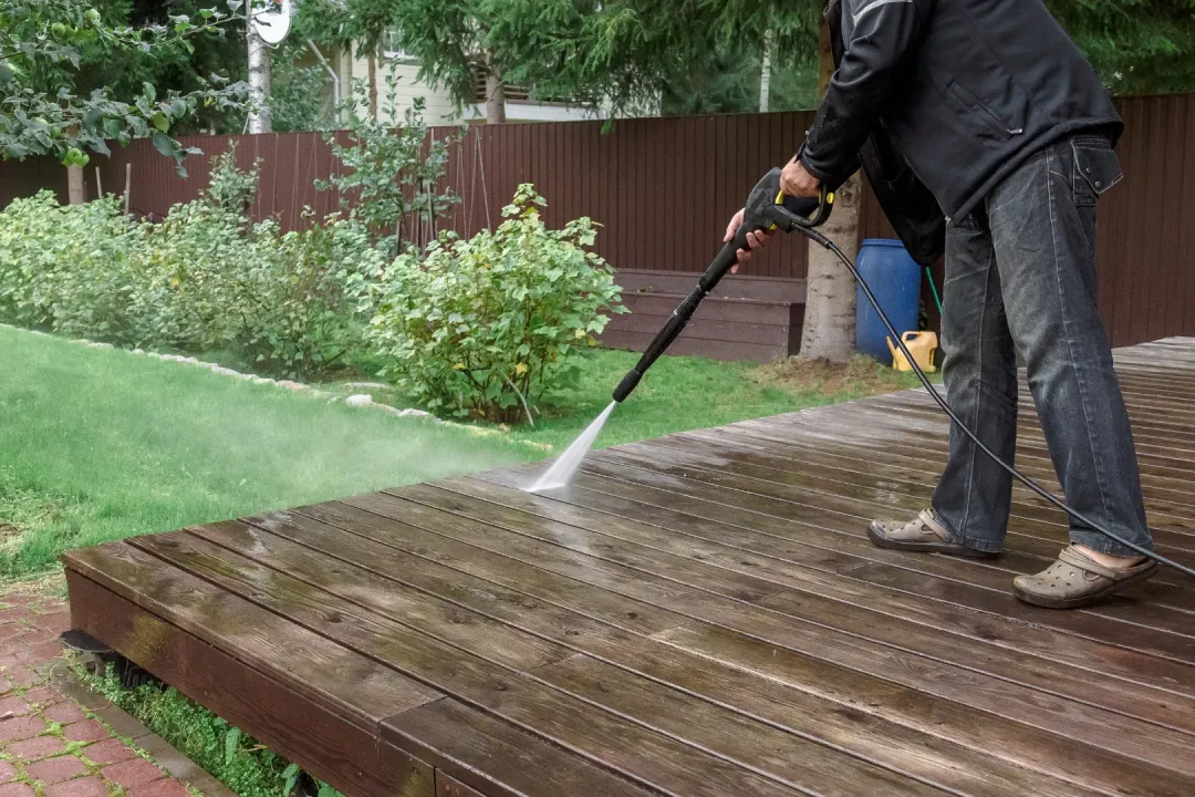 A person cleaning a composite with pressure water