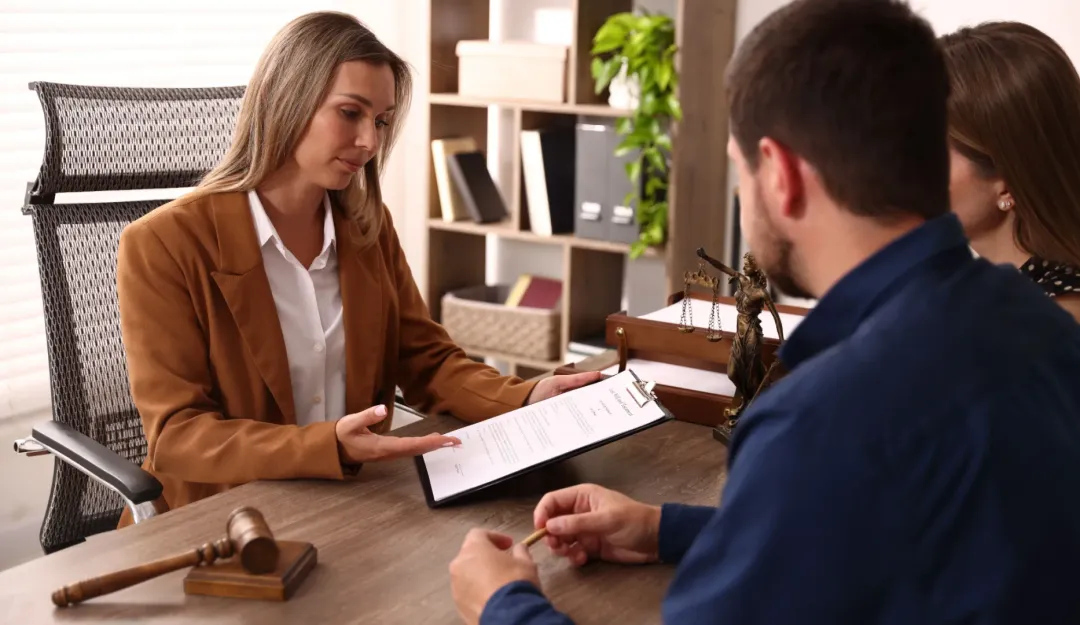 A bail bondsman explaining the paperwork to a client.