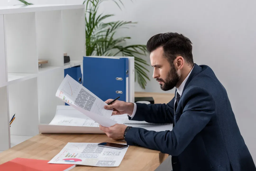 A bail bondsman reviewing documents before approving a bail bond.